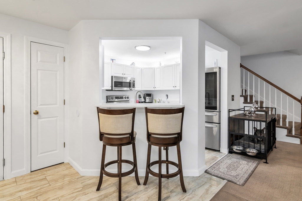 1 Riverview Boulevard, Unit 7204 Methuen, MA 01844 - Photo 10 of 29 a dining room with furniture and wooden floor