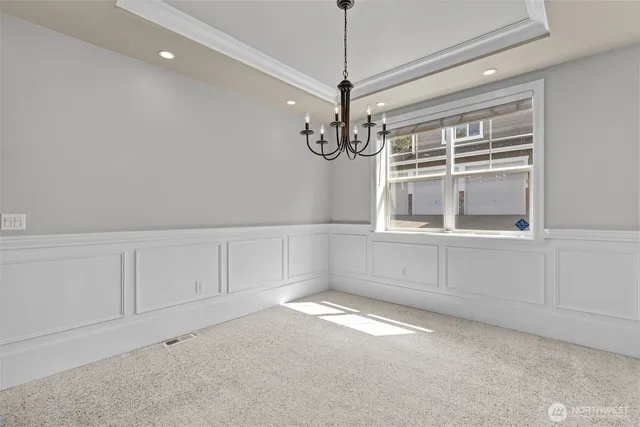 a view of a livingroom with a staircase a ceiling fan and window