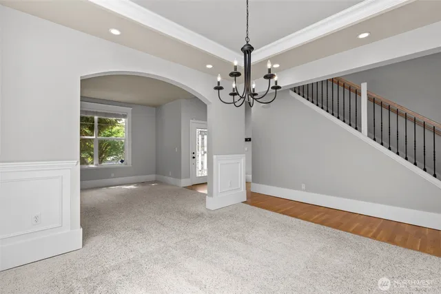 a view of an empty room with a window and a fireplace