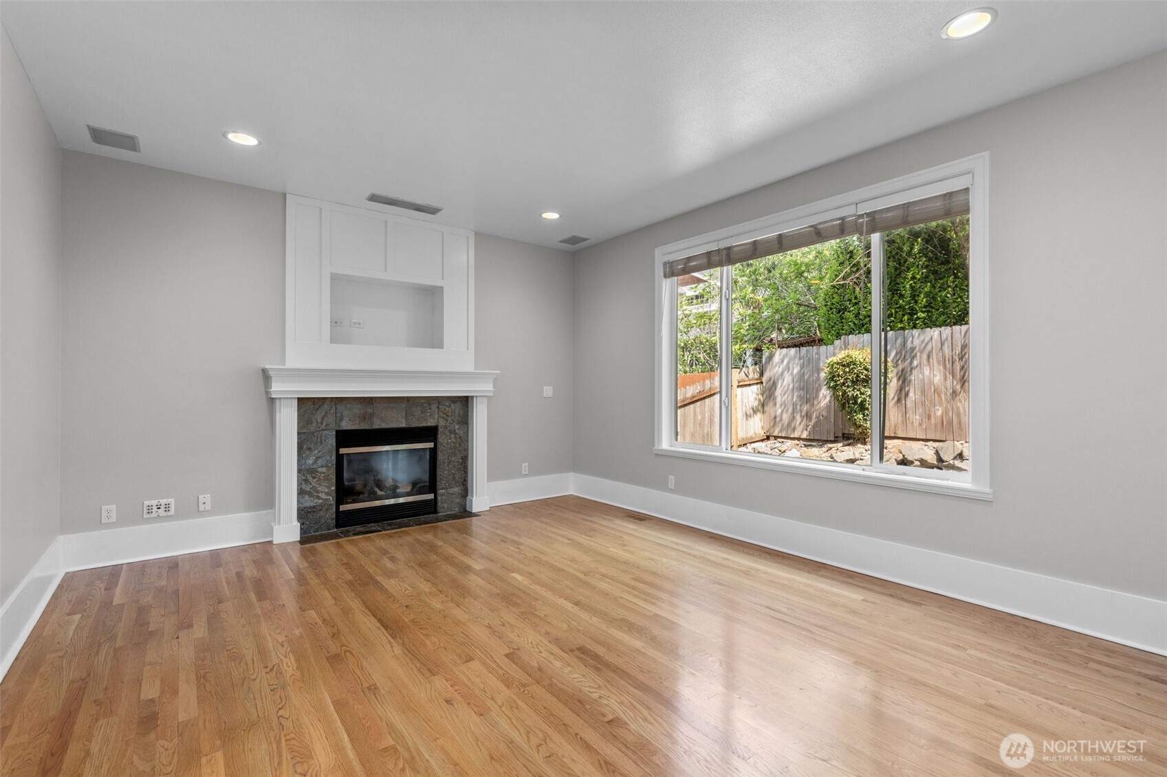 2528 Camas Avenue Northeast Renton, WA 98056 - Photo 19 of 28 a view of an empty room with a window and a fireplace