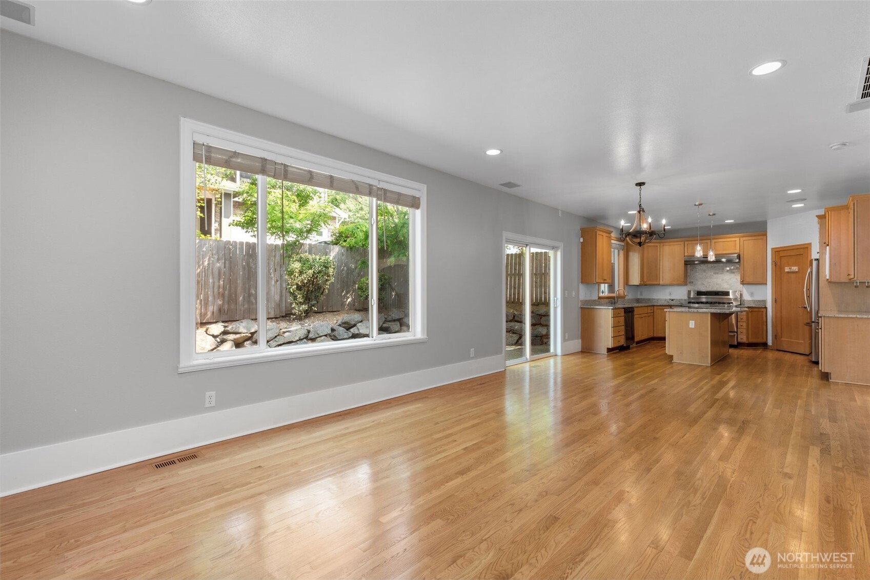 2528 Camas Avenue Northeast Renton, WA 98056 - Photo 20 of 28 an empty room with a wooden floor and windows