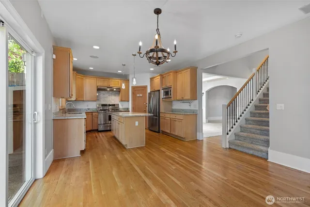 a kitchen with a stove a sink and a refrigerator