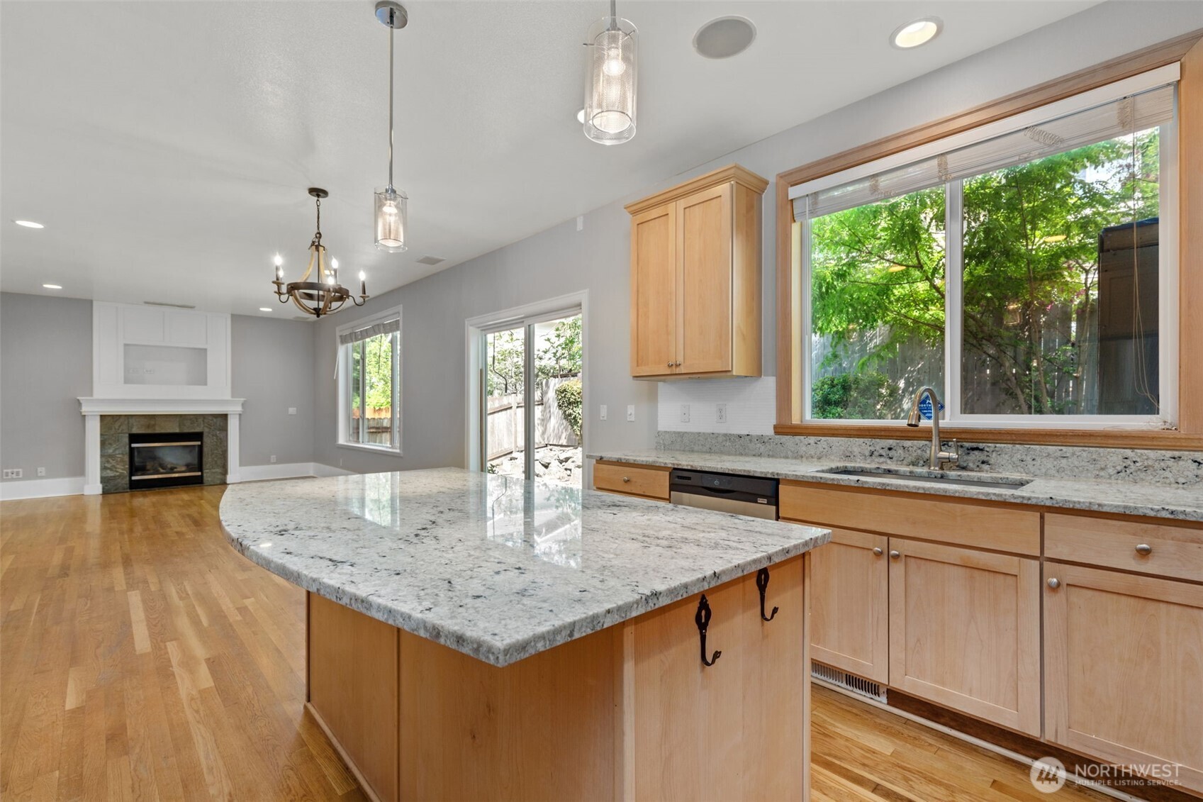 2528 Camas Avenue Northeast Renton, WA 98056 - Photo 10 of 28 a kitchen with granite countertop center island wooden floor and a large window