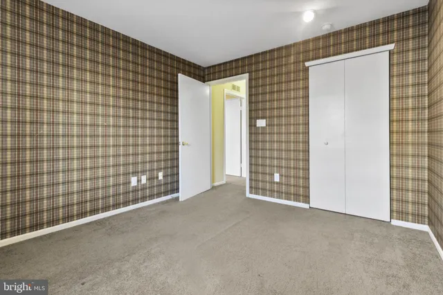a view of a livingroom with wooden floor and next to a window