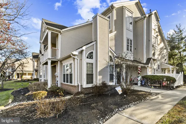 a view of a large white house with a street