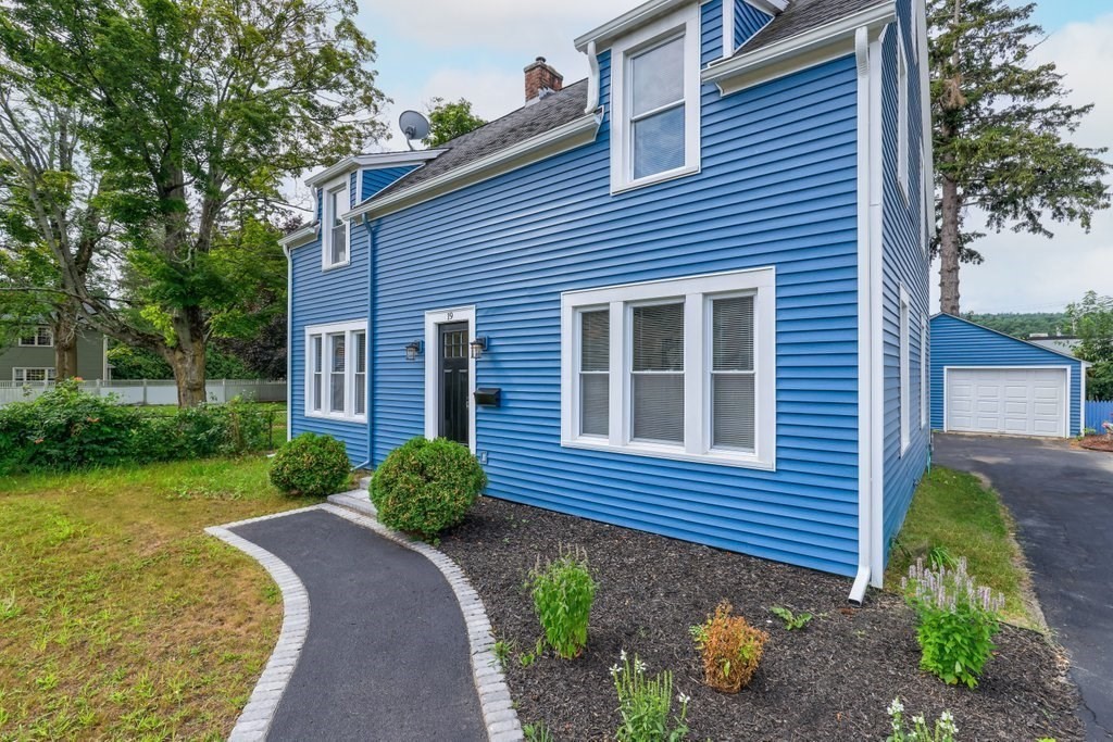 19 Converse Street Palmer, MA 01069 - Photo 1 of 28 a brick house with a yard plants and a large tree