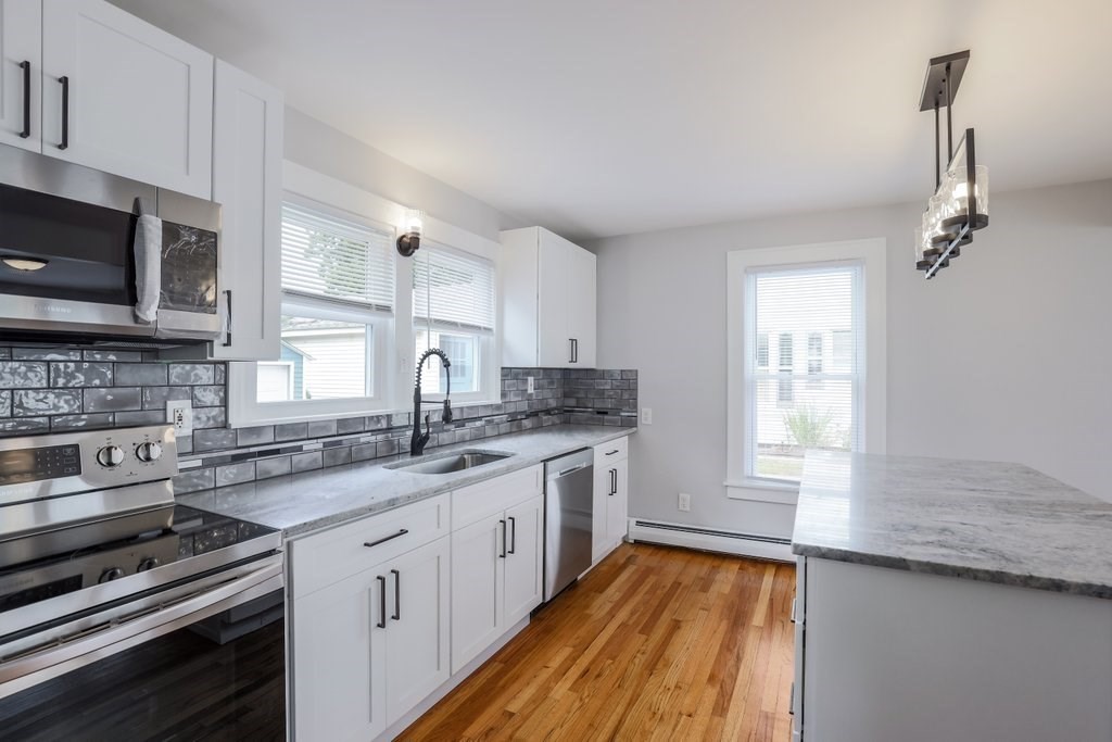 19 Converse Street Palmer, MA 01069 - Photo 11 of 28 a kitchen with a sink stove microwave and cabinets