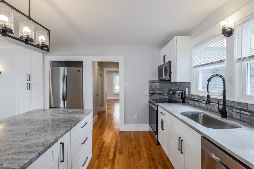19 Converse Street Palmer, MA 01069 - Photo 12 of 28 a kitchen with granite countertop a sink a counter space appliances and cabinets