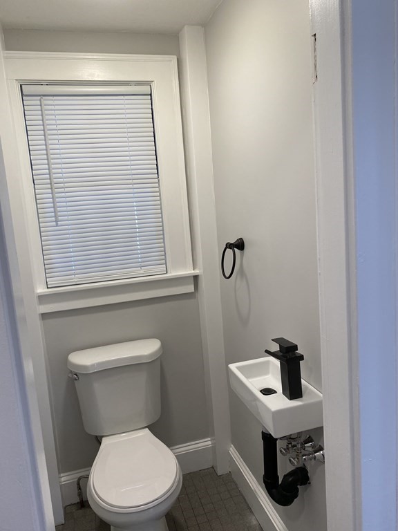 19 Converse Street Palmer, MA 01069 - Photo 14 of 28 a white toilet sitting next to a bathroom sink