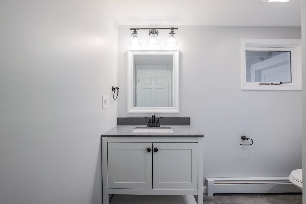19 Converse Street Palmer, MA 01069 - Photo 20 of 28 a bathroom with a granite countertop sink a toilet and mirror