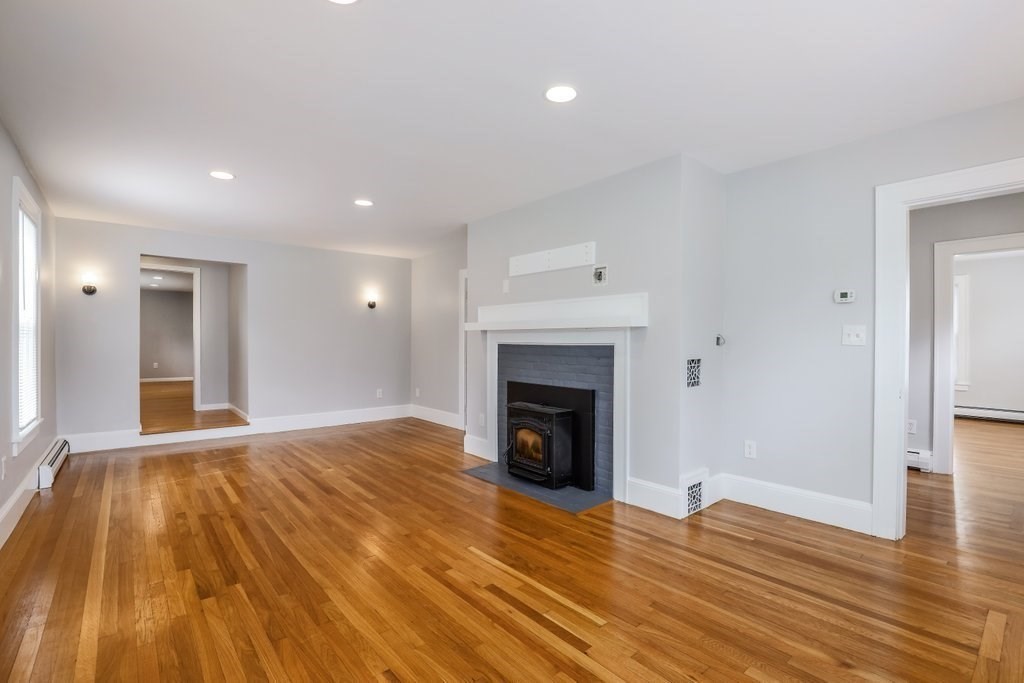 19 Converse Street Palmer, MA 01069 - Photo 5 of 28 a view of empty room with wooden floor and fireplace