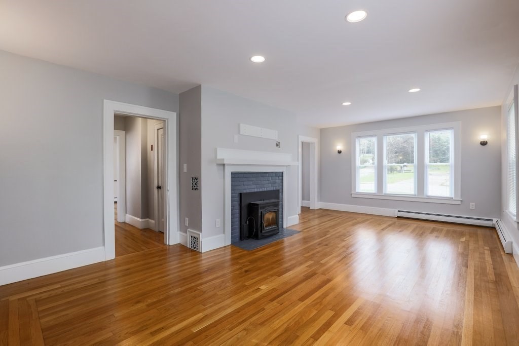 19 Converse Street Palmer, MA 01069 - Photo 6 of 28 a view of a livingroom with wooden floor and a fireplace