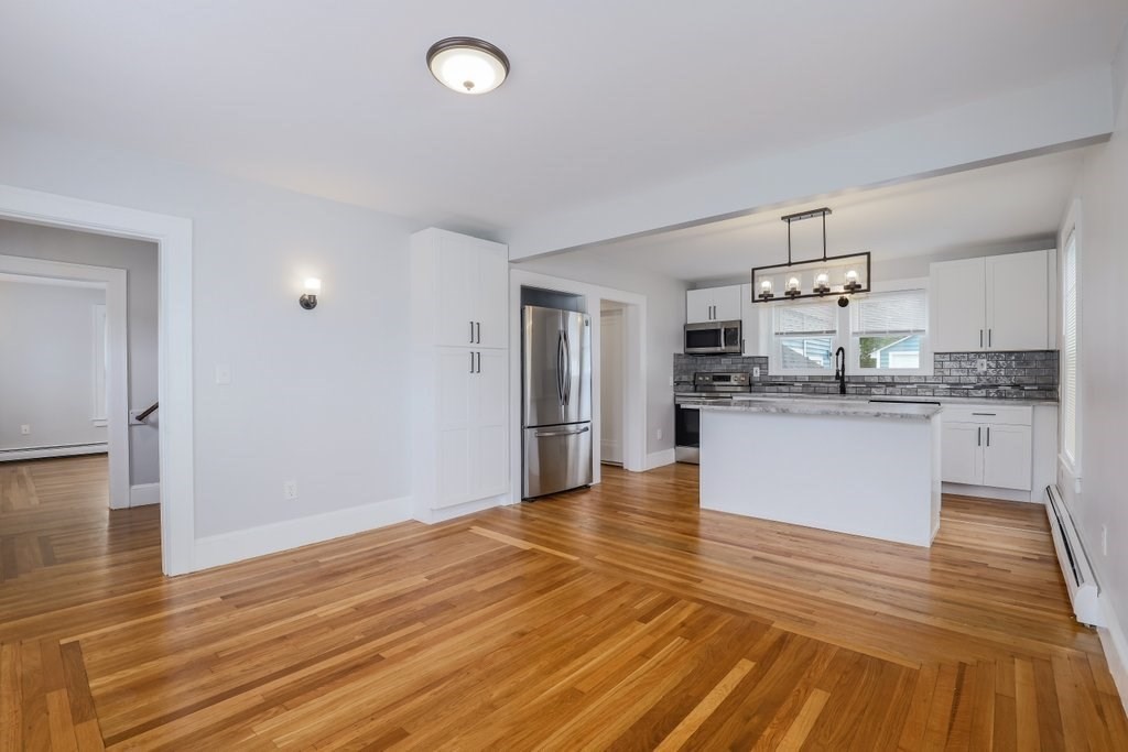 19 Converse Street Palmer, MA 01069 - Photo 7 of 28 a large kitchen with kitchen island a sink dishwasher a refrigerator and wooden floor