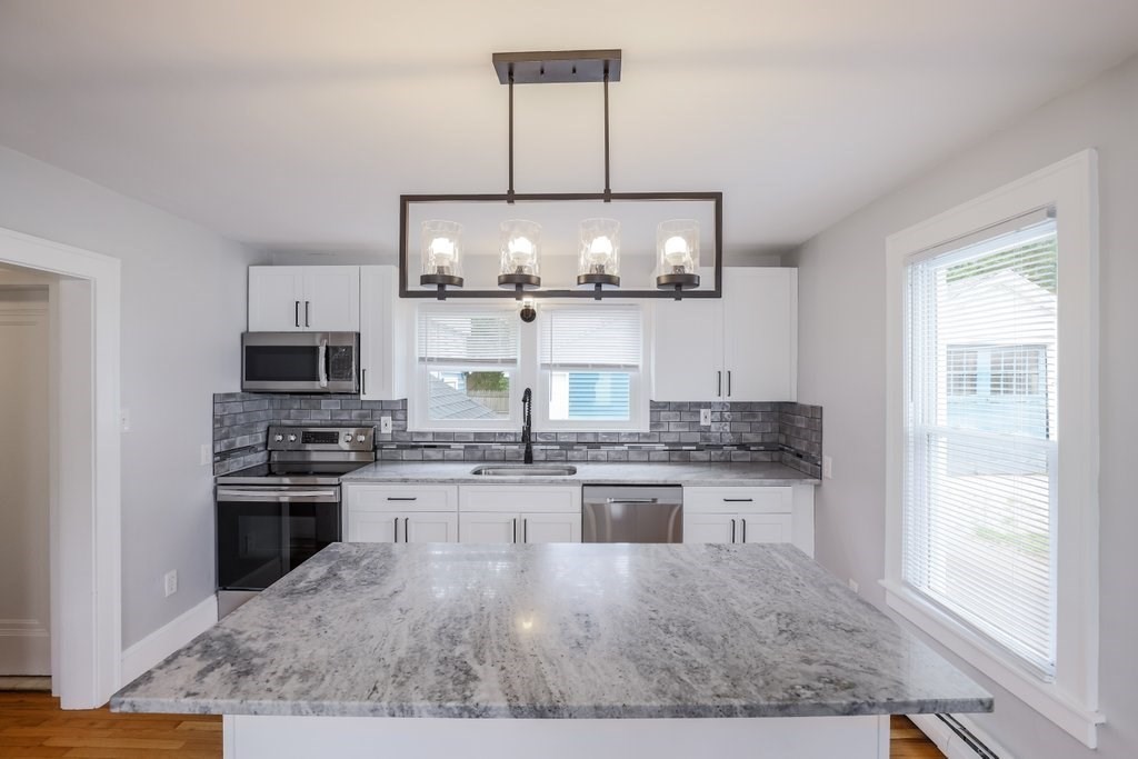 19 Converse Street Palmer, MA 01069 - Photo 8 of 28 a kitchen with stainless steel appliances granite countertop a stove and a sink
