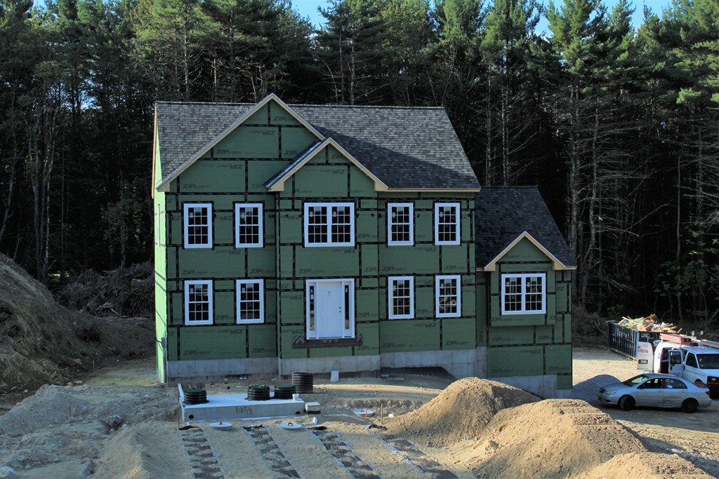 73 Meadow Road Townsend, MA 01469 - Photo 1 of 25 a front view of a house with a yard and garage