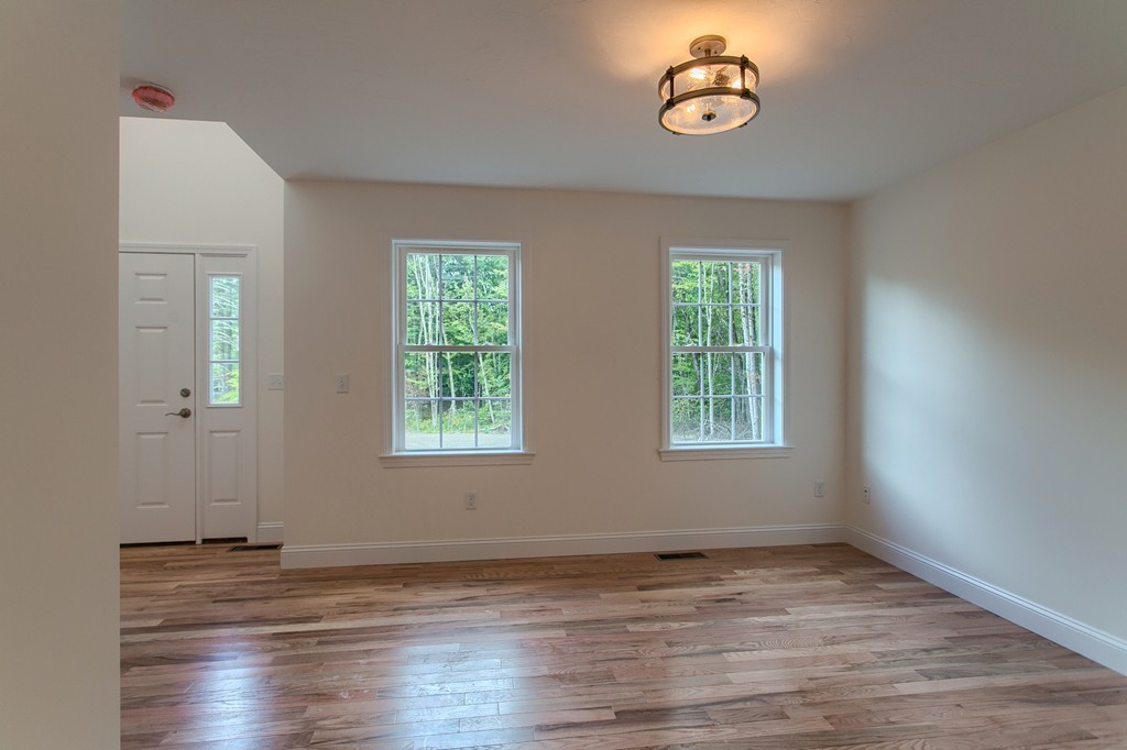73 Meadow Road Townsend, MA 01469 - Photo 11 of 25 a view of empty room with wooden floor and window