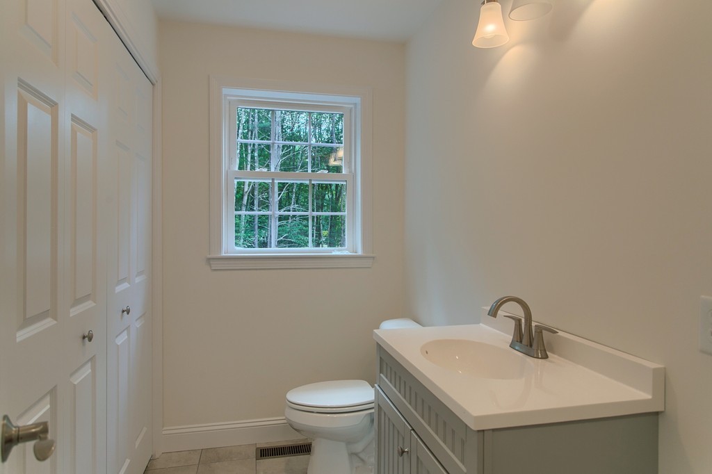 73 Meadow Road Townsend, MA 01469 - Photo 12 of 25 a bathroom with a sink toilet and a mirror