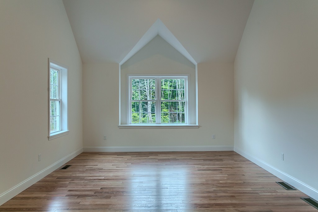 73 Meadow Road Townsend, MA 01469 - Photo 15 of 25 a view of an empty room with wooden floor and a window