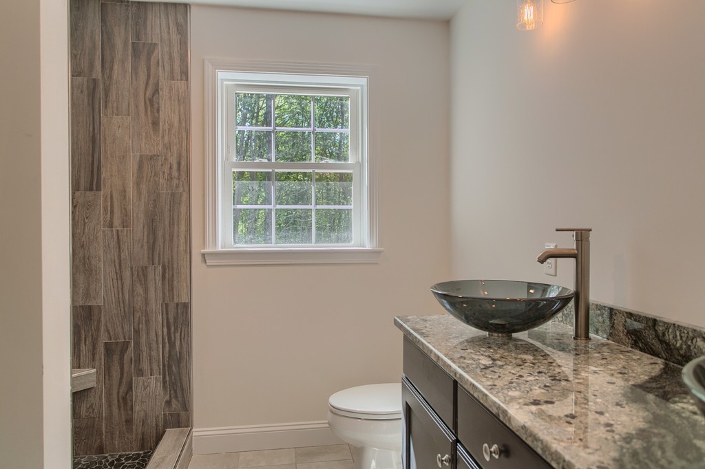 73 Meadow Road Townsend, MA 01469 - Photo 22 of 25 a bathroom with a granite countertop toilet sink and mirror