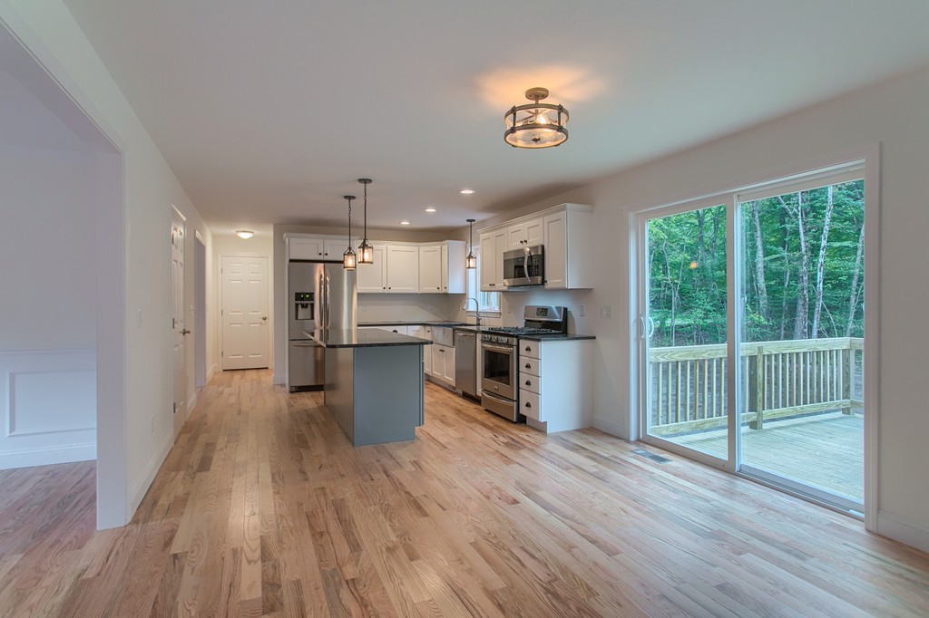 73 Meadow Road Townsend, MA 01469 - Photo 3 of 25 a kitchen with a refrigerator and wooden floor