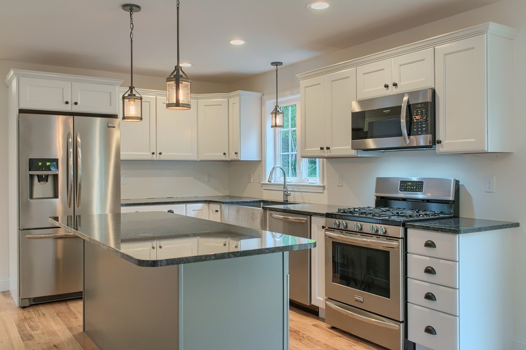 73 Meadow Road Townsend, MA 01469 - Photo 5 of 25 a kitchen with stainless steel appliances granite countertop a stove a refrigerator and a sink