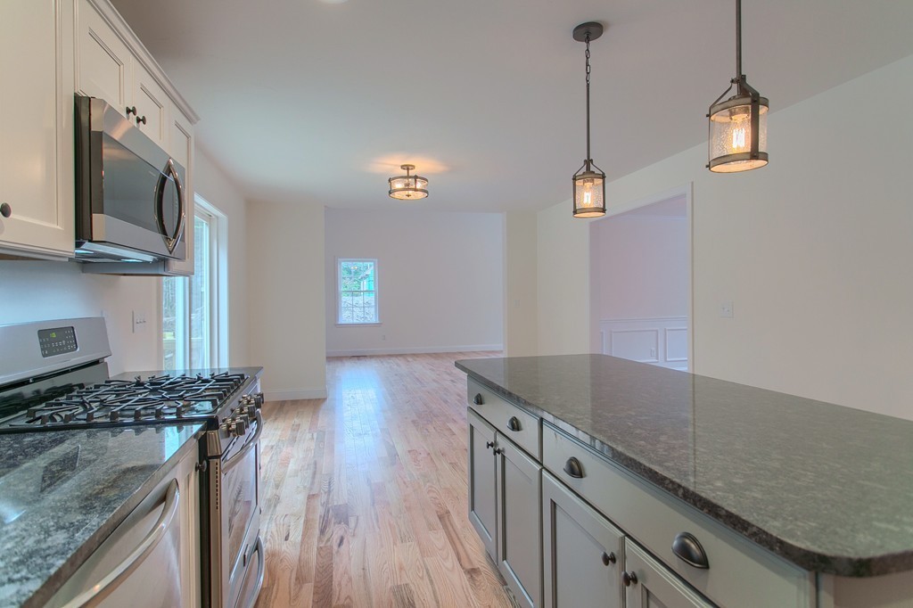 73 Meadow Road Townsend, MA 01469 - Photo 6 of 25 a kitchen with granite countertop a sink and a stove