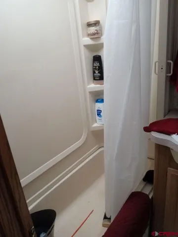 a view of a kitchen with a sink and cabinets