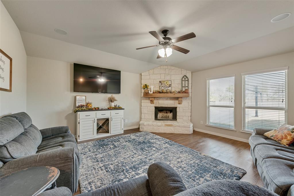 343 Amber Lane Nevada, TX 75173 - Photo 14 of 33 a living room with furniture a fireplace and a flat screen tv