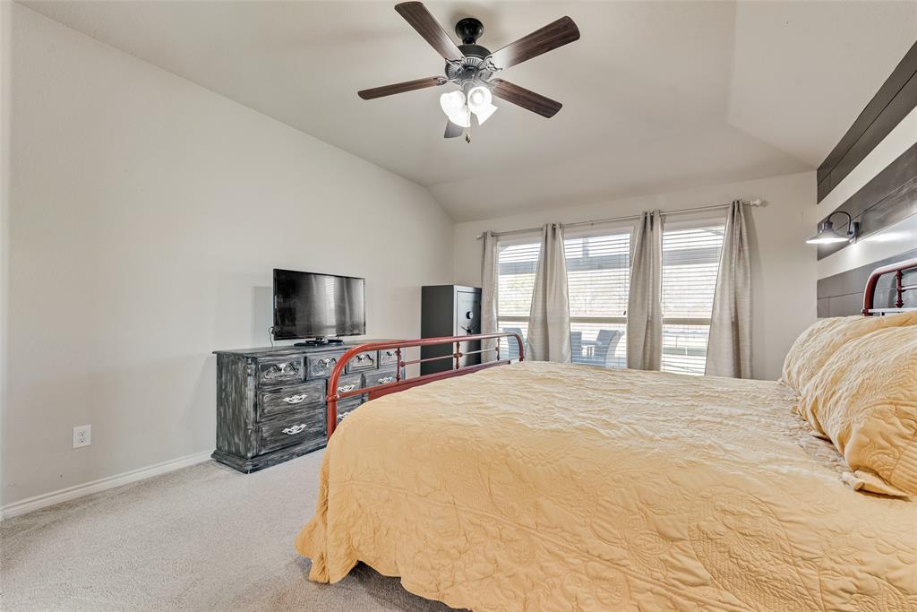 343 Amber Lane Nevada, TX 75173 - Photo 21 of 33 a bedroom with a bed and a flat screen tv