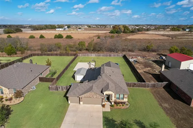 an aerial view of a house with a lake view