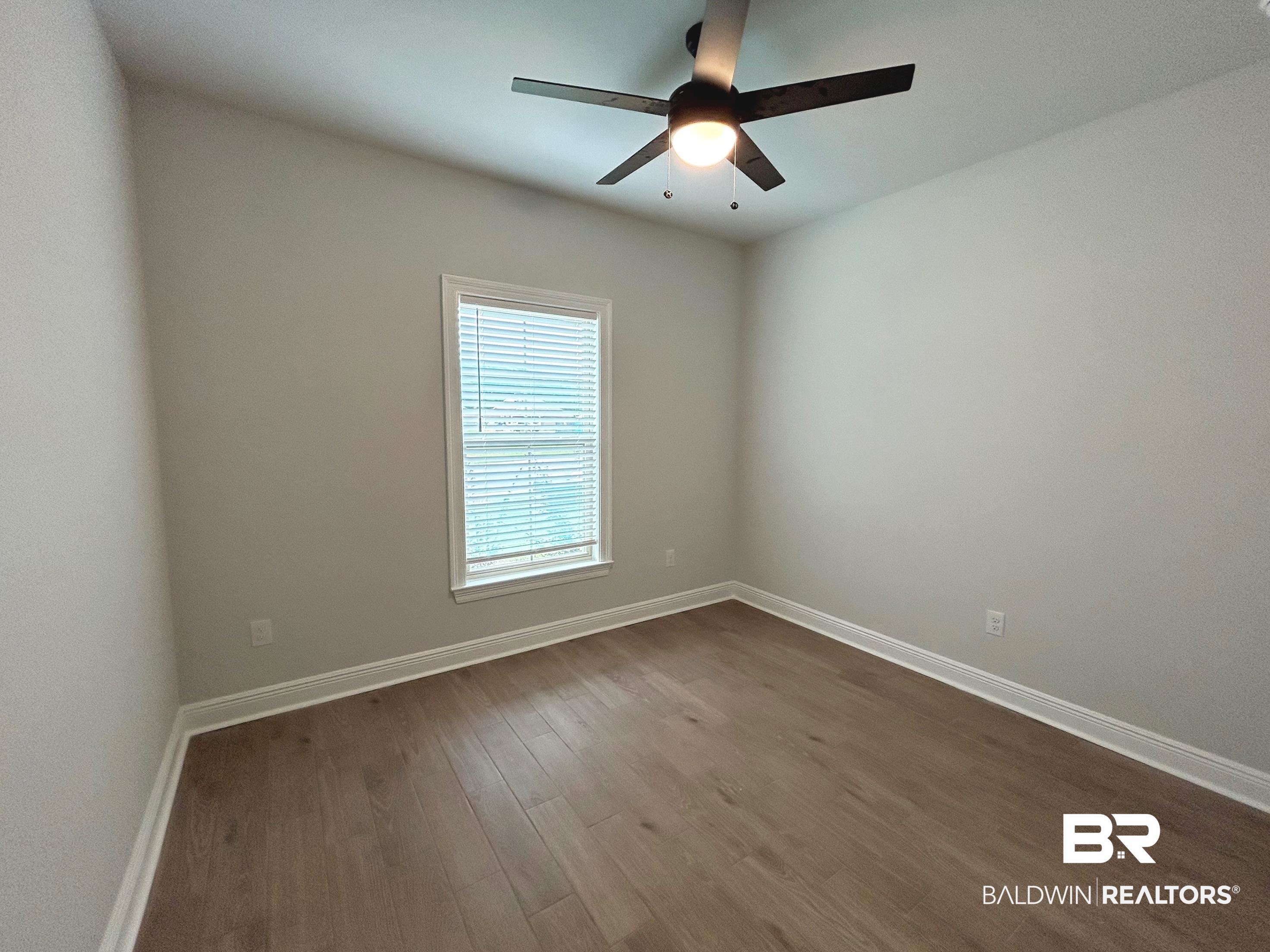860 Sumter Loop Foley, AL 36535 - Photo 17 of 26 Empty room with ceiling fan and wood-type flooring