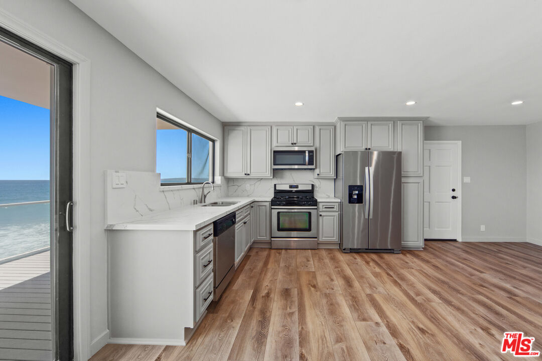 25218 Malibu Road Malibu, CA 90265 - Photo 4 of 9 a kitchen with stainless steel appliances a refrigerator and a sink