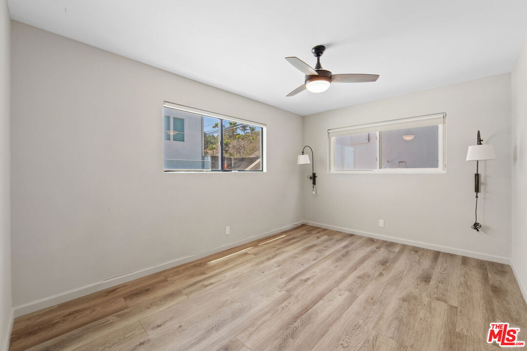 25218 Malibu Road Malibu, CA 90265 - Photo 5 of 9 a view of empty room with wooden floor and fan