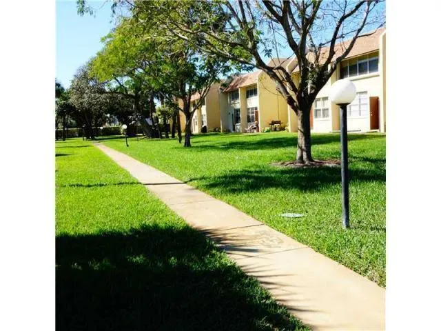 a view of a house with pool and a yard