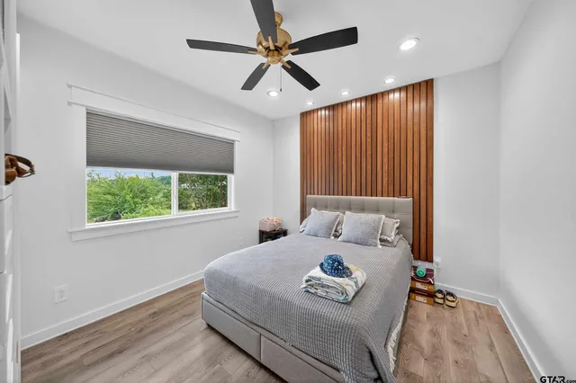 a bedroom with a bed and a chandelier