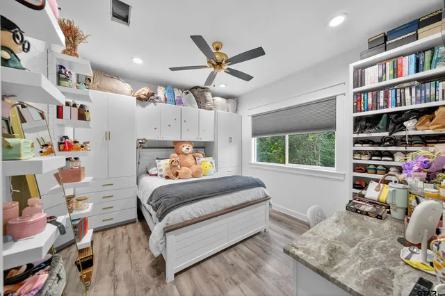 a bedroom with furniture and a book shelf