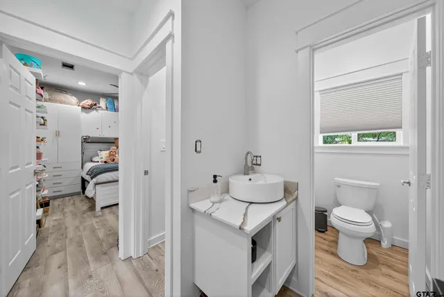 a bedroom with furniture and a flat screen tv