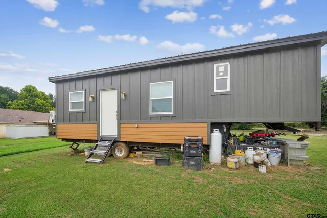a front view of house with yard and outdoor seating