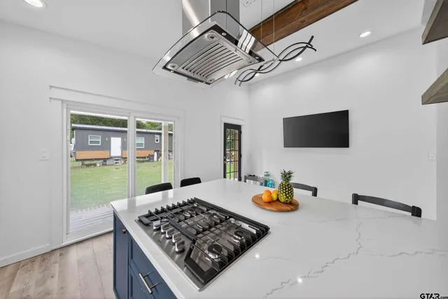 a kitchen view of a stove and a refrigerator