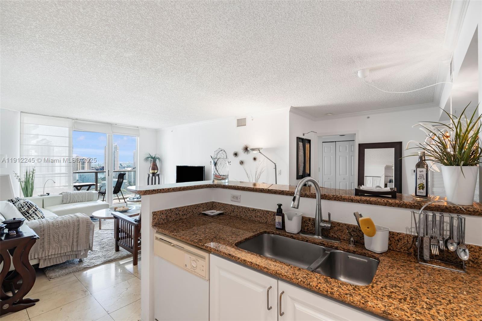 1155 Brickell Bay Drive, Unit 2708 Miami, FL 33131 - Photo 11 of 19 a kitchen with a sink stove and cabinets