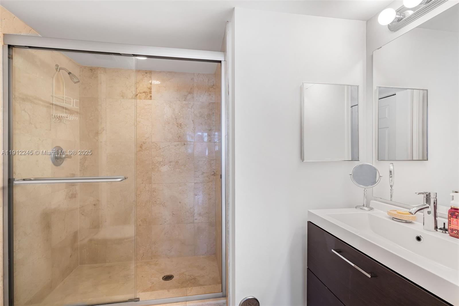 1155 Brickell Bay Drive, Unit 2708 Miami, FL 33131 - Photo 12 of 19 a bathroom with a shower and a sink