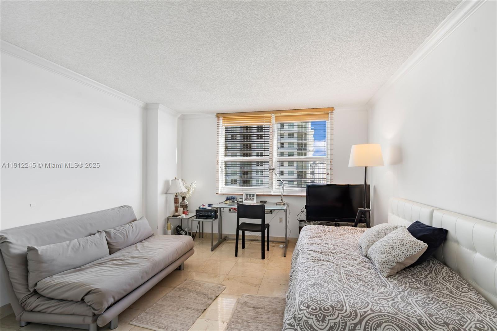 1155 Brickell Bay Drive, Unit 2708 Miami, FL 33131 - Photo 13 of 19 a living room with furniture lamp and window