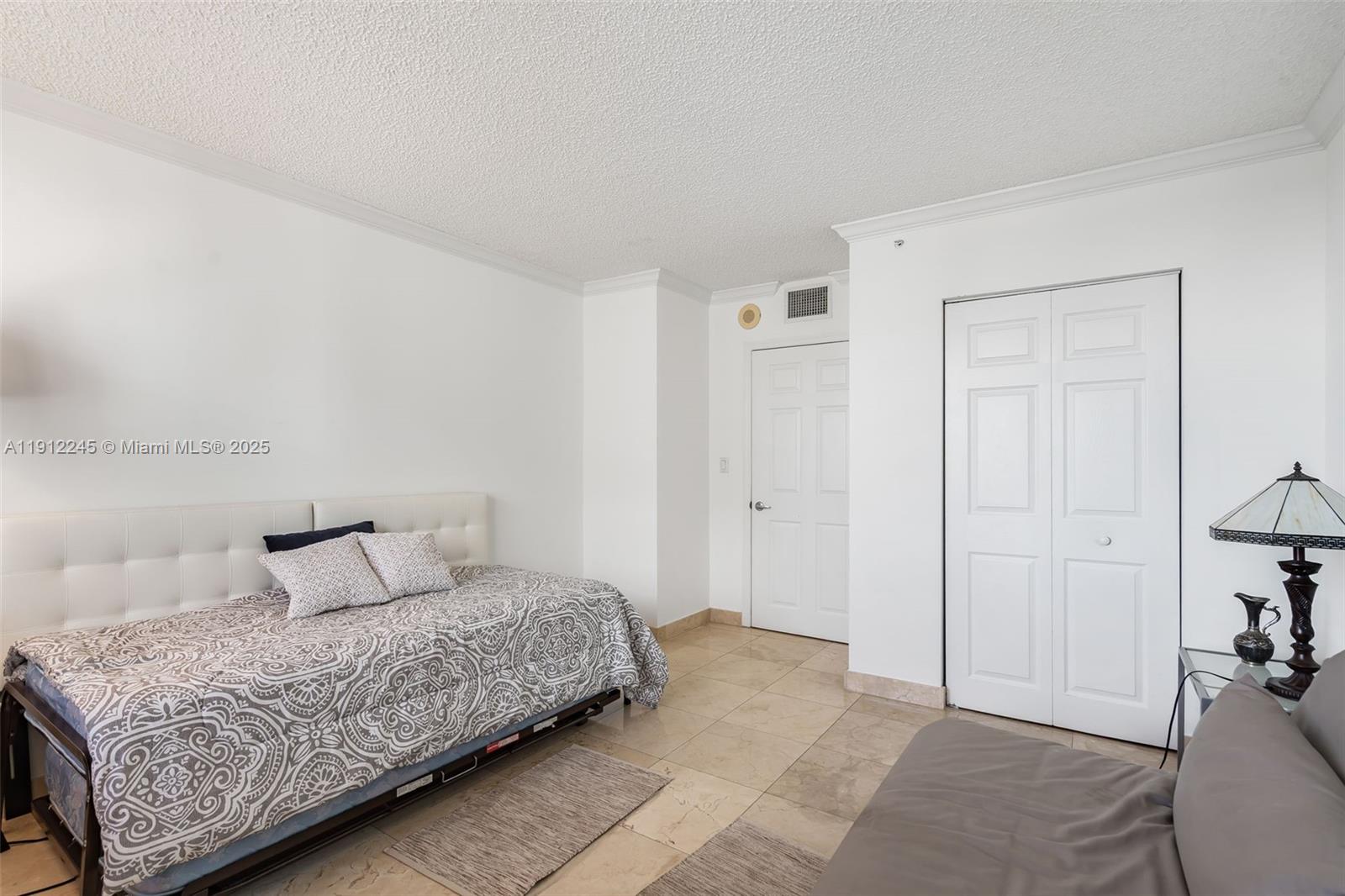 1155 Brickell Bay Drive, Unit 2708 Miami, FL 33131 - Photo 14 of 19 a bedroom with a bed and a closet