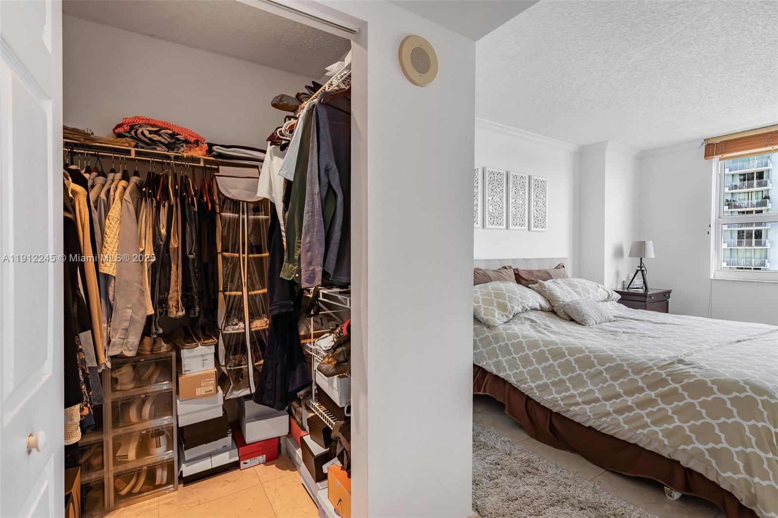 1155 Brickell Bay Drive, Unit 2708 Miami, FL 33131 - Photo 17 of 19 a bedroom with a bed and a window