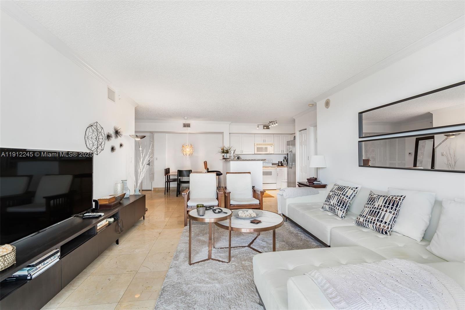 1155 Brickell Bay Drive, Unit 2708 Miami, FL 33131 - Photo 8 of 19 a living room with furniture and a flat screen tv