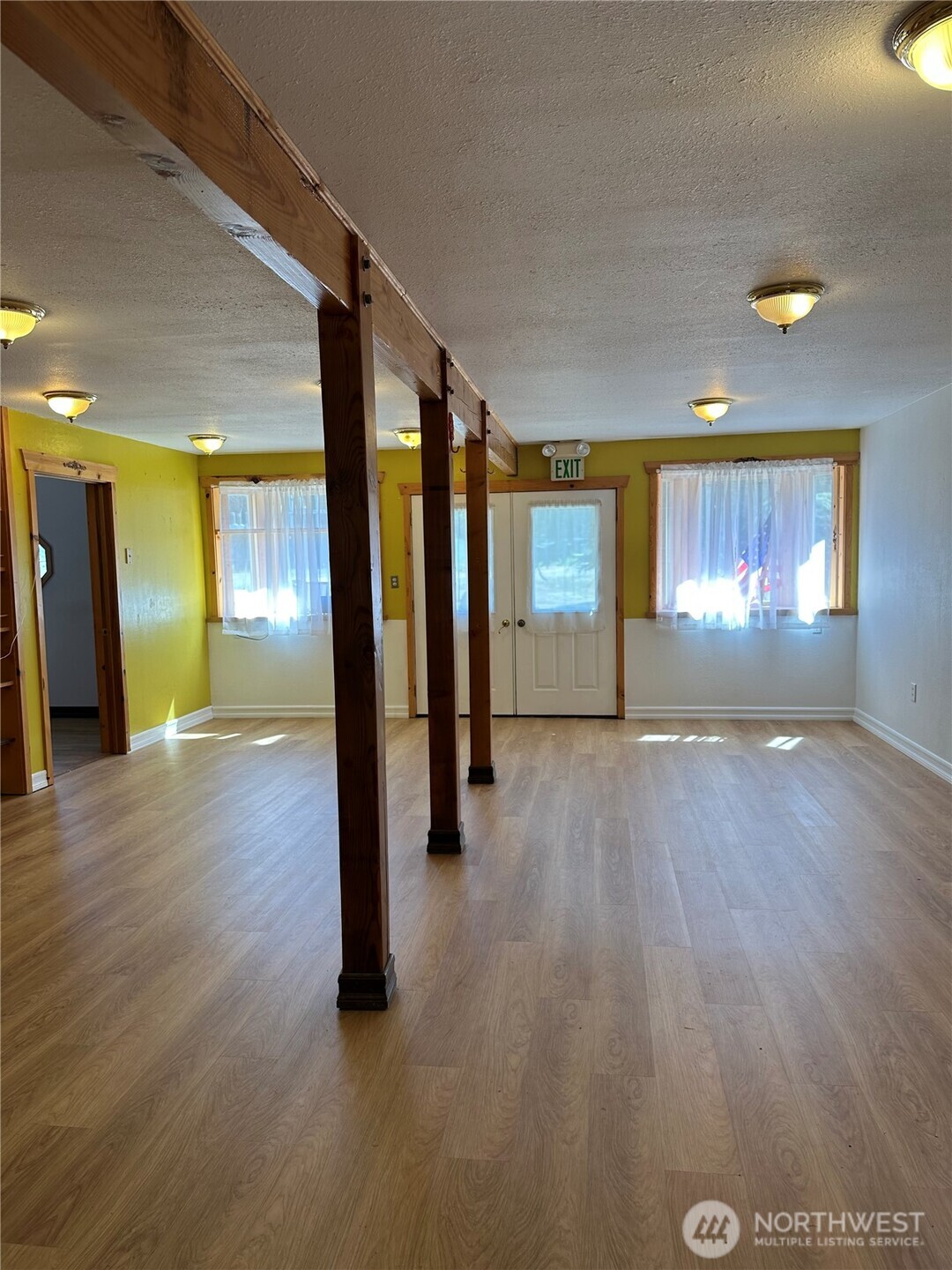641 Decatur Head Drive Decatur Island, WA 98221 - Photo 13 of 40 an empty room with wooden floor and windows