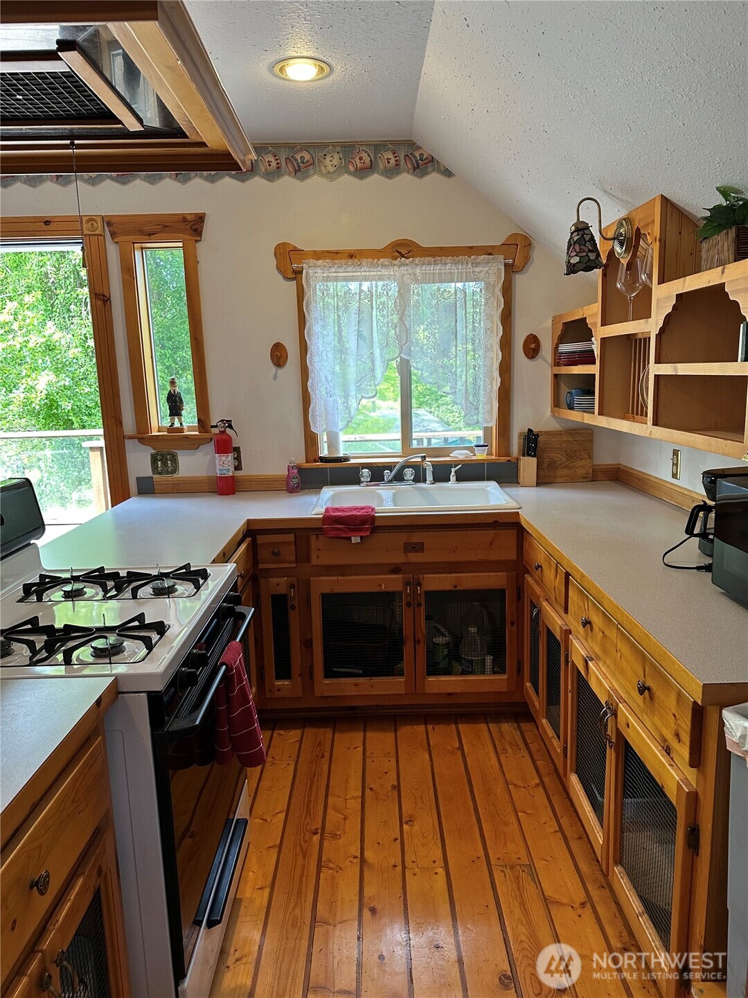 641 Decatur Head Drive Decatur Island, WA 98221 - Photo 22 of 40 a kitchen with a stove and a sink