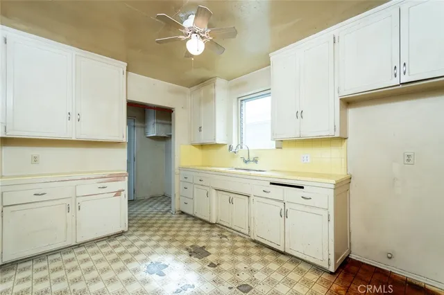 a kitchen with a sink and cabinets