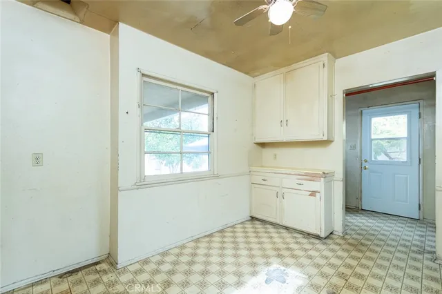 a kitchen with a stove cabinets and a refrigerator