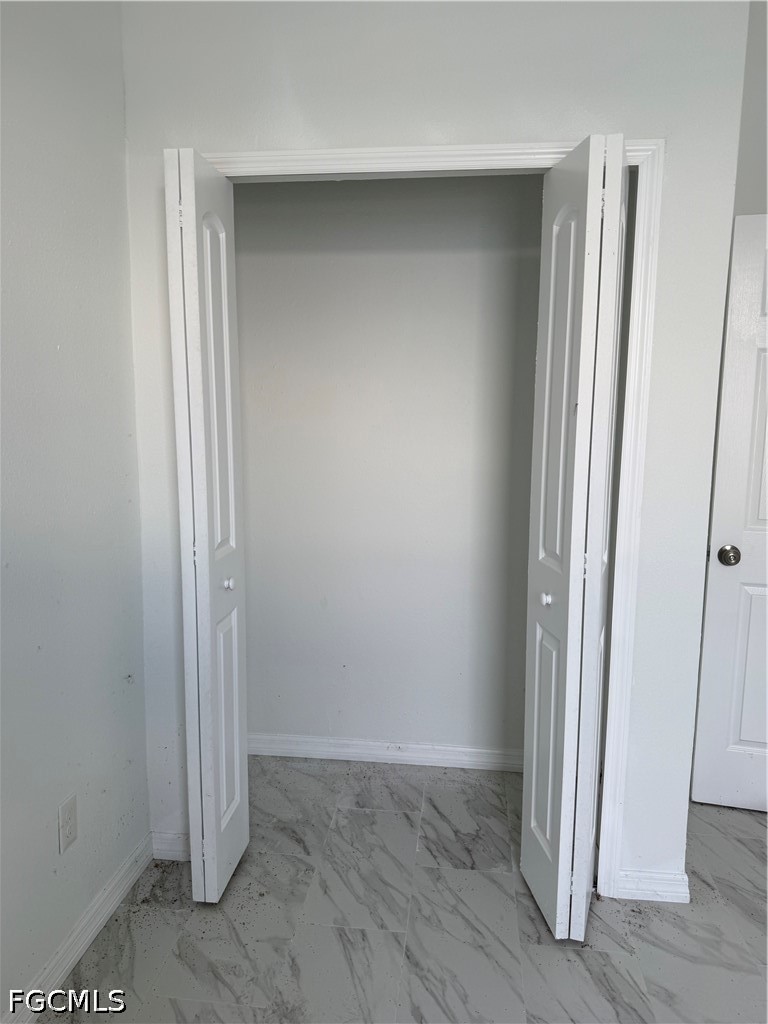 10658 Rainsville Street Port Charlotte, FL 33981 - Photo 14 of 21 an empty room with wooden floor and windows